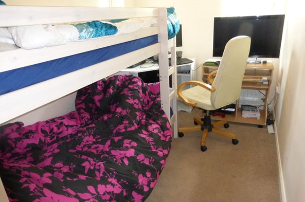 Small bedroom with bed and desk